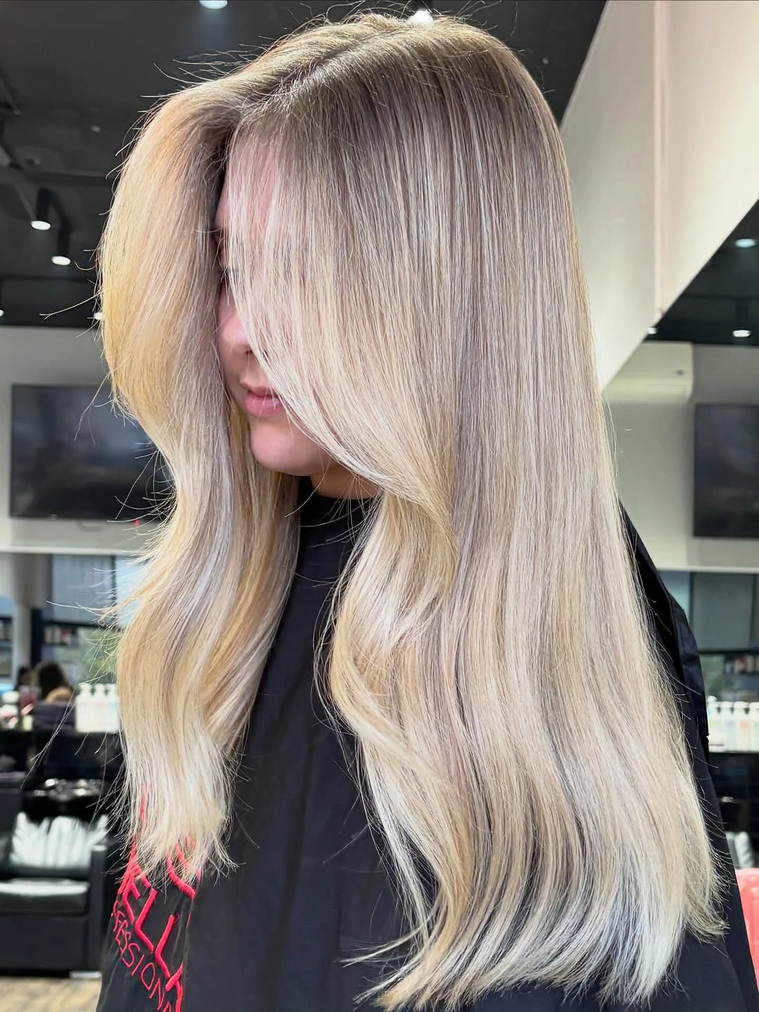 Long pale platinum blonde hair with faint pink tones and softly curved ends