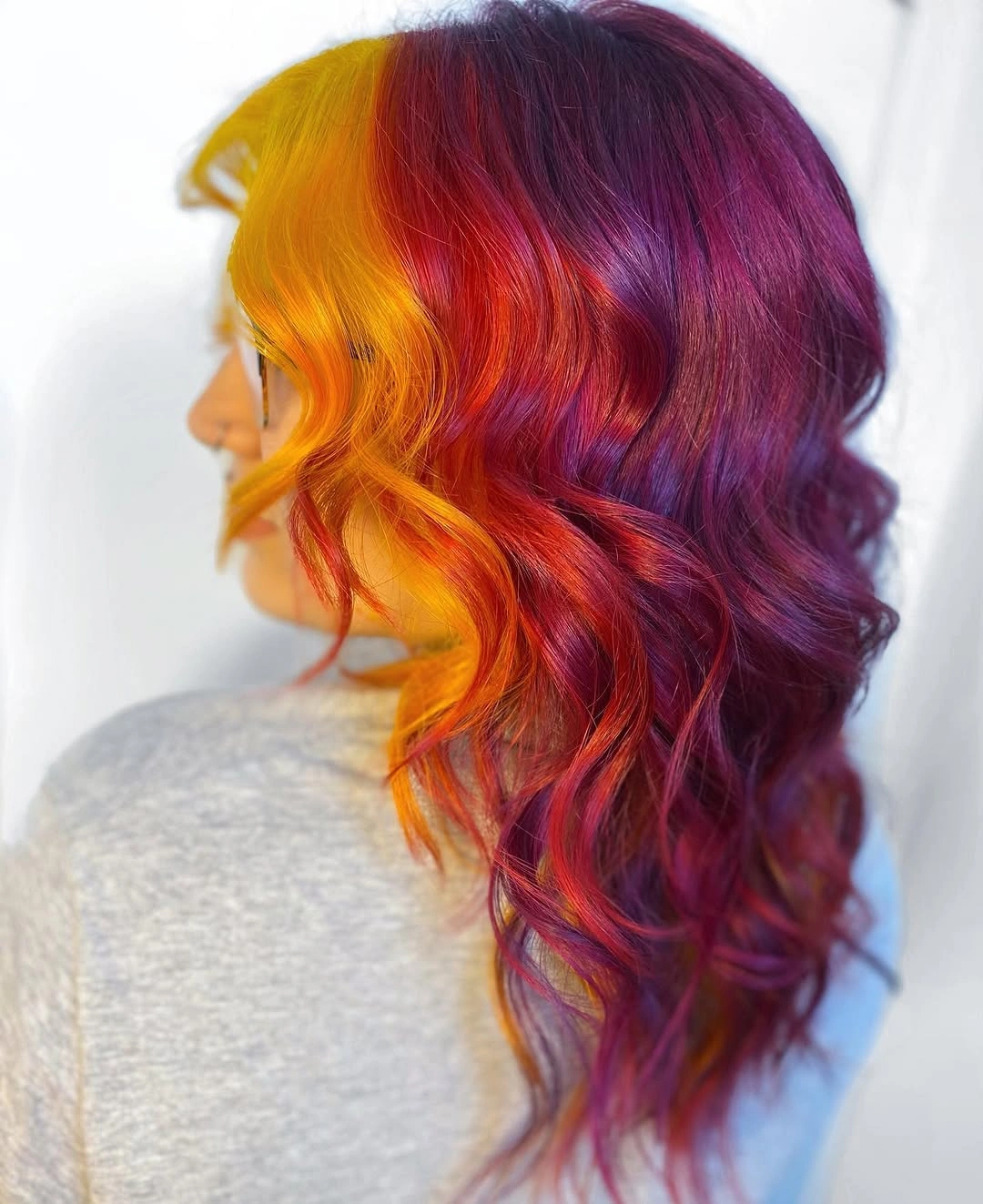 Medium long wavy hair combining golden yellow orange red pink and purple
