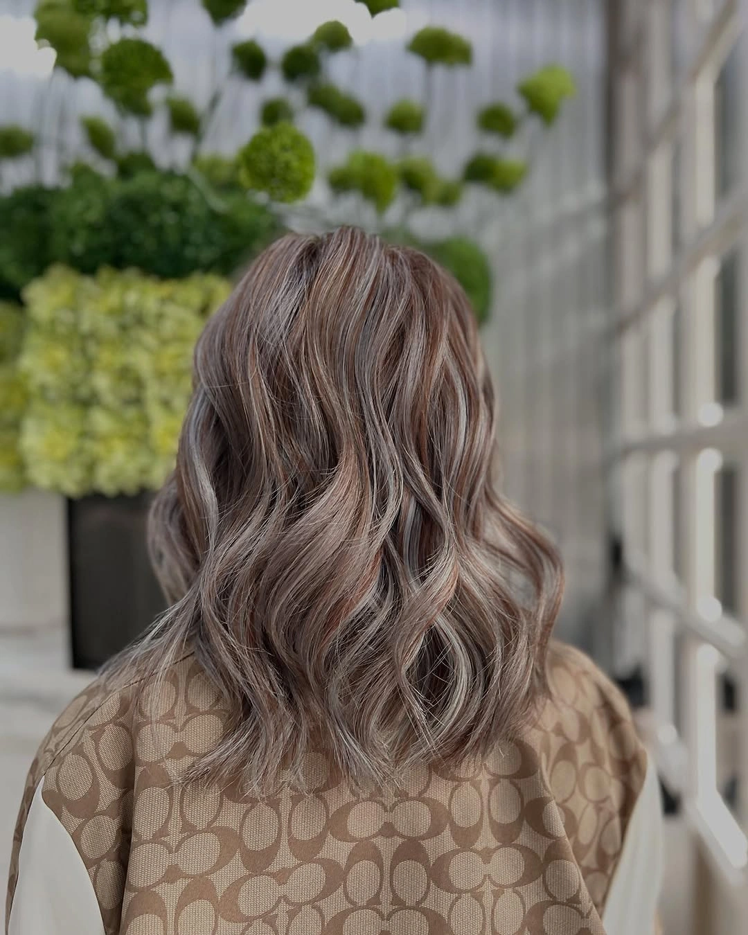 Medium length taupe brown wavy hair with cool beige brown highlights