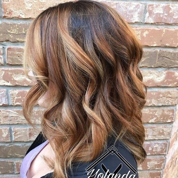 Medium long chocolate brown wavy hair with broad caramel golden highlights