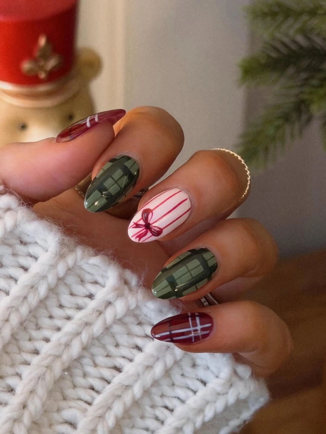 Green plaid almond nails with burgundy stripes and red ribbon artwork