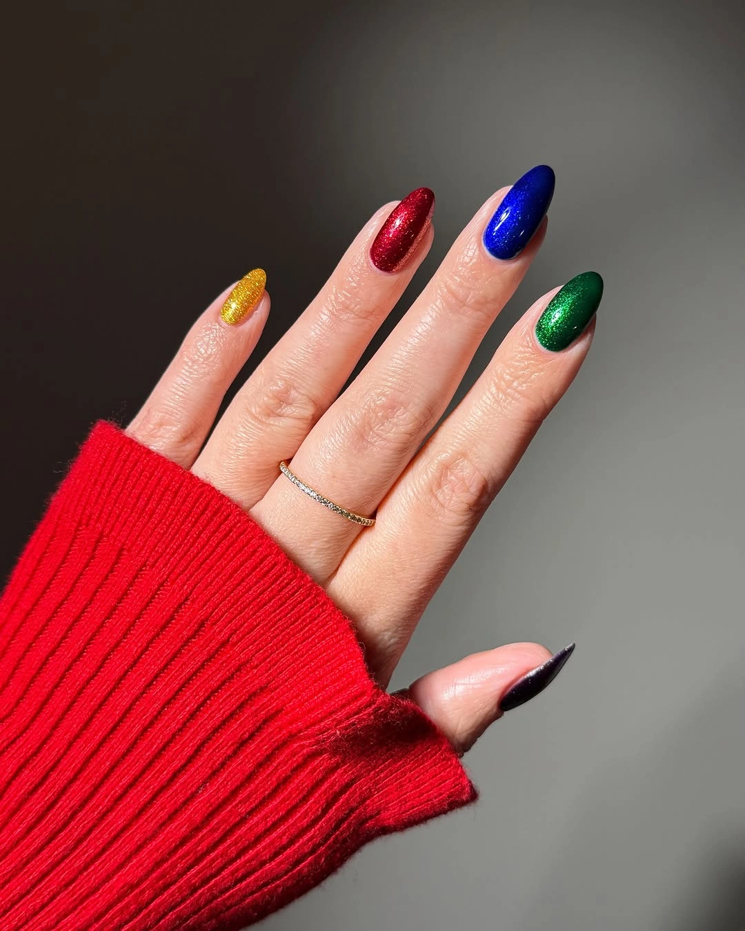 Almond nails in shimmering gold red blue green and near black