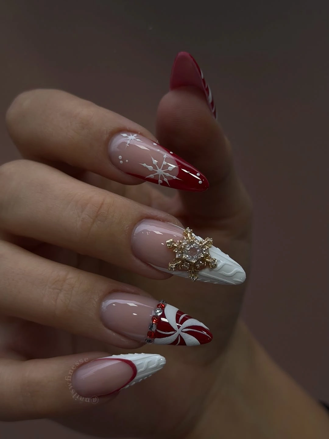 Long red and white holiday nails with snowflakes and jeweled ornament