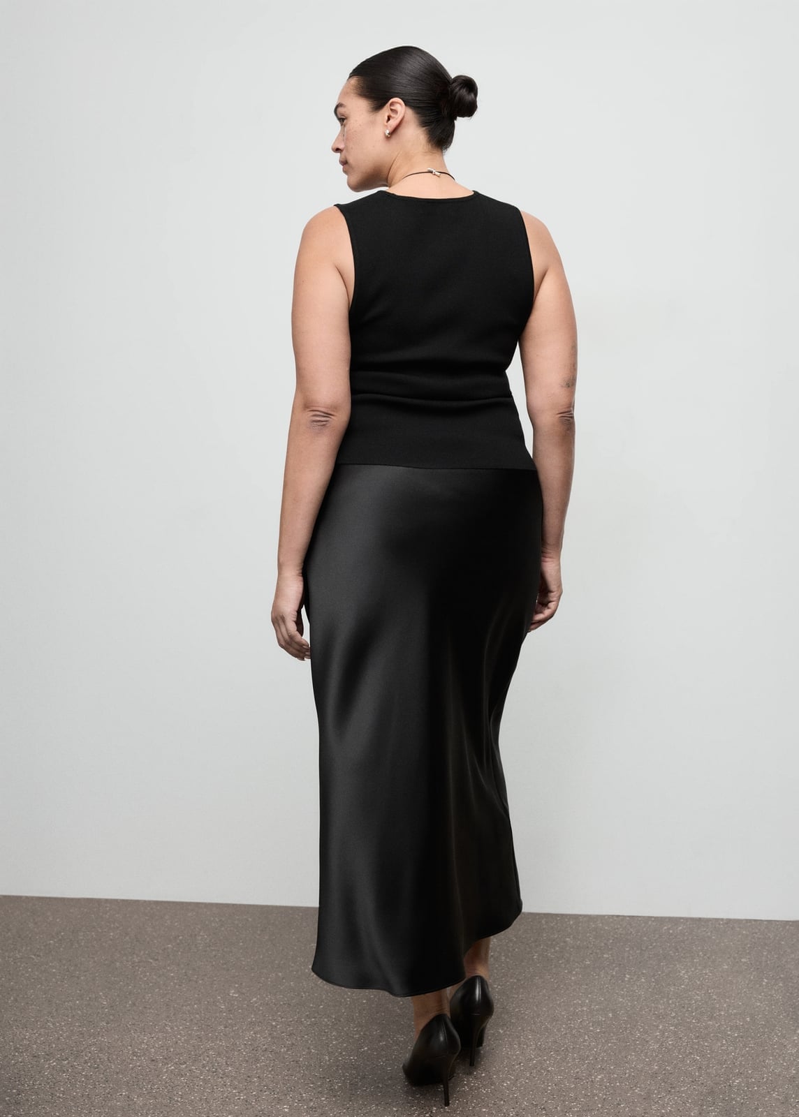Black satin A-line skirt with sleeveless knit top — Elegant Black Satin Skirt Outfit