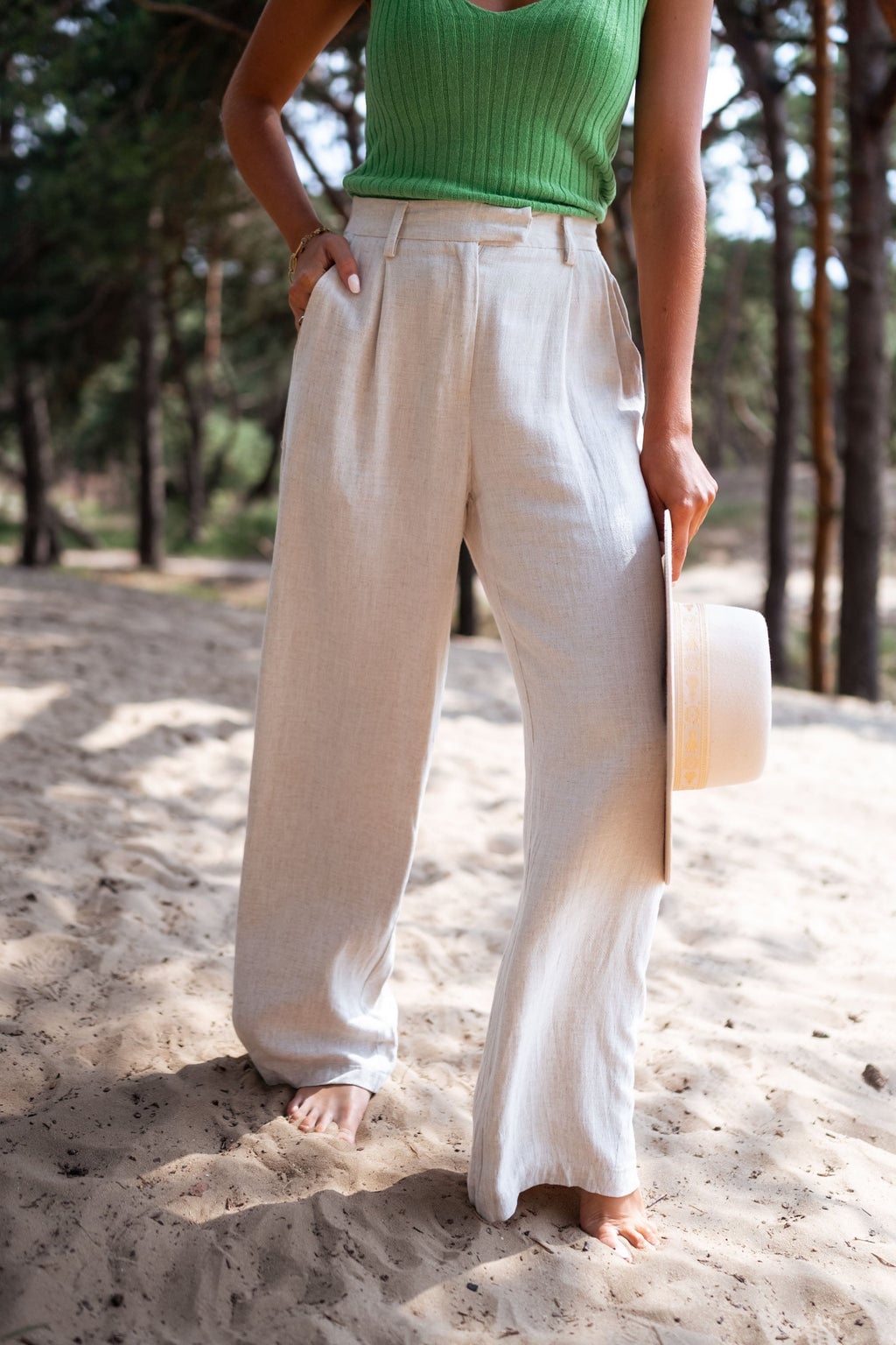 High-waisted beige linen trousers with a green knit top — Simple Beige Pants Outfits