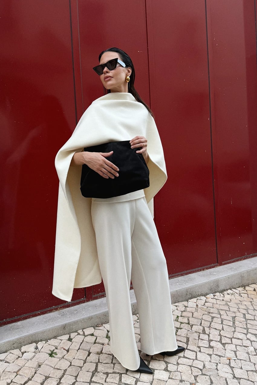 Ivory wide-leg trousers with a dramatic draped cape — Simple Beige Pants Outfits