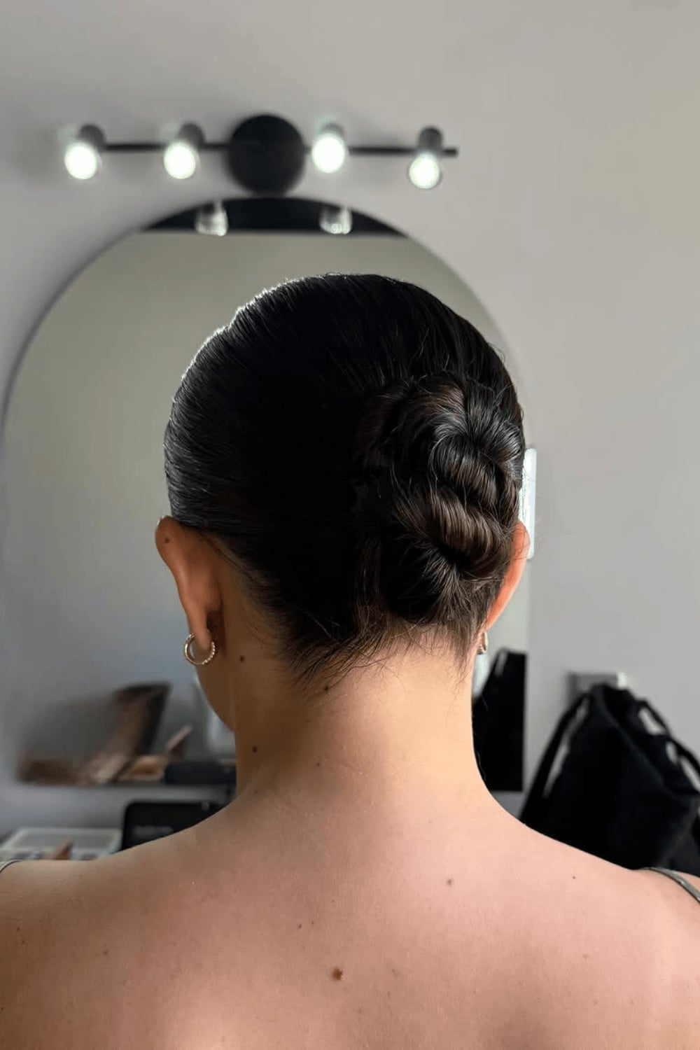 Dark Brown Twisted Low Bun, Highlighting The Hair'S Natural Sheen Dark Brown Twisted Low Bun, Highlighting The Hair'S Natural Sheen — Simple Casual Updo