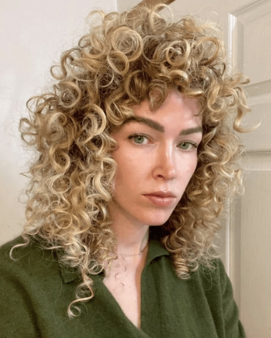 Shoulder Length Honey Blonde Wolf Cut With Curls, Curly Bangs — Simple Curly Wolf Cut