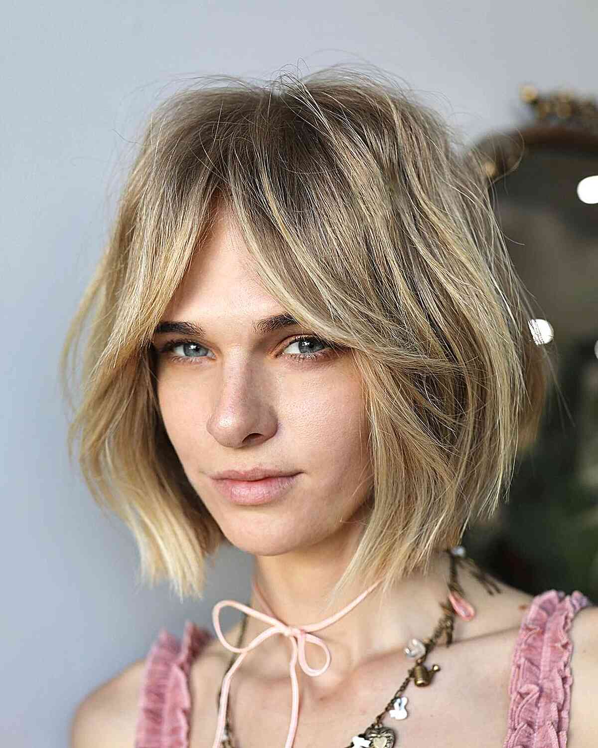 Chin Length Ash Blonde Textured Bob With Tousled Curtain Bangs Chin Length Ash Blonde Textured Bob With Tousled Curtain Bangs — Simple Curtain Bangs