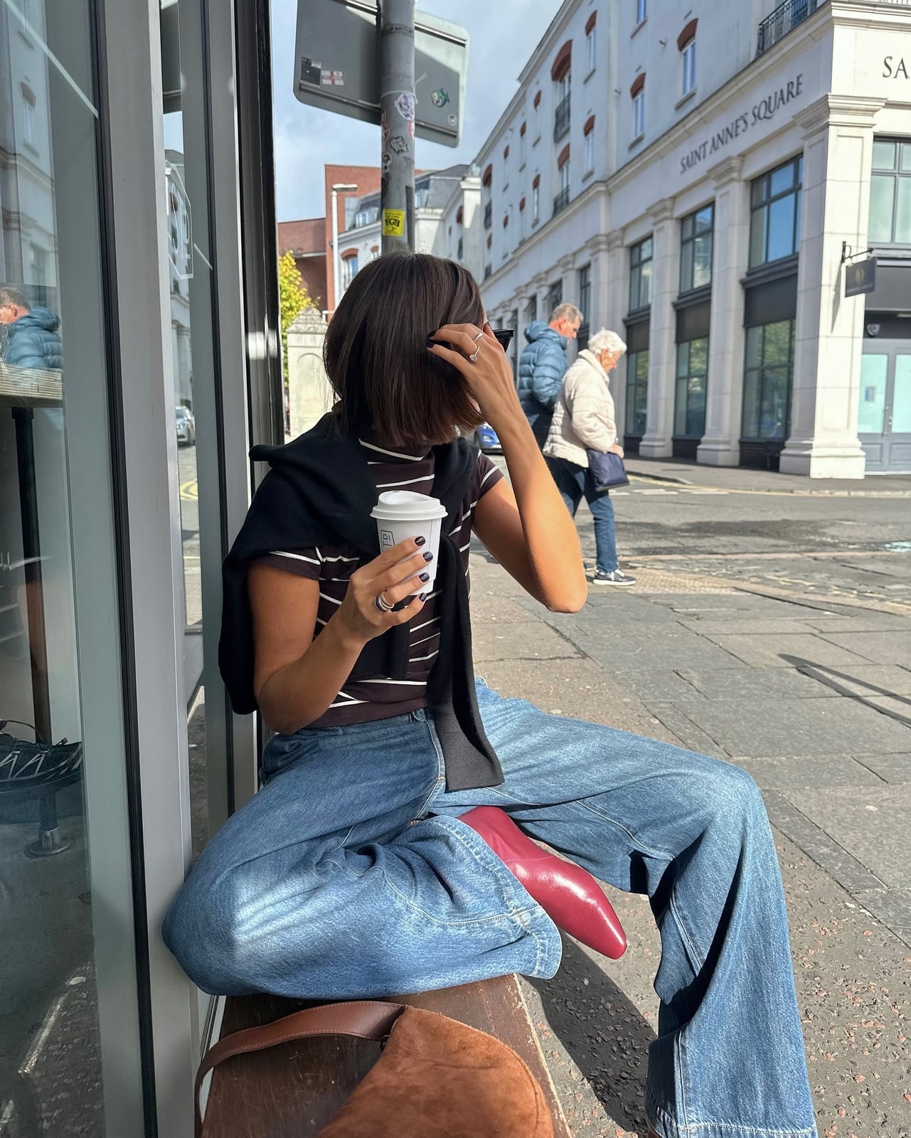 Striped t-shirt with sweater tied over wide leg jeans — Simple Layered Ideas
