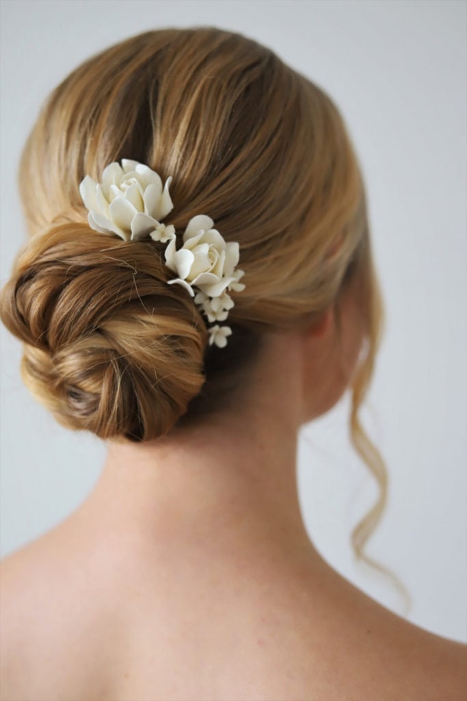 Blonde Wavy Low Bun With Floral Accent — Simple Low Bun Wedding Hair