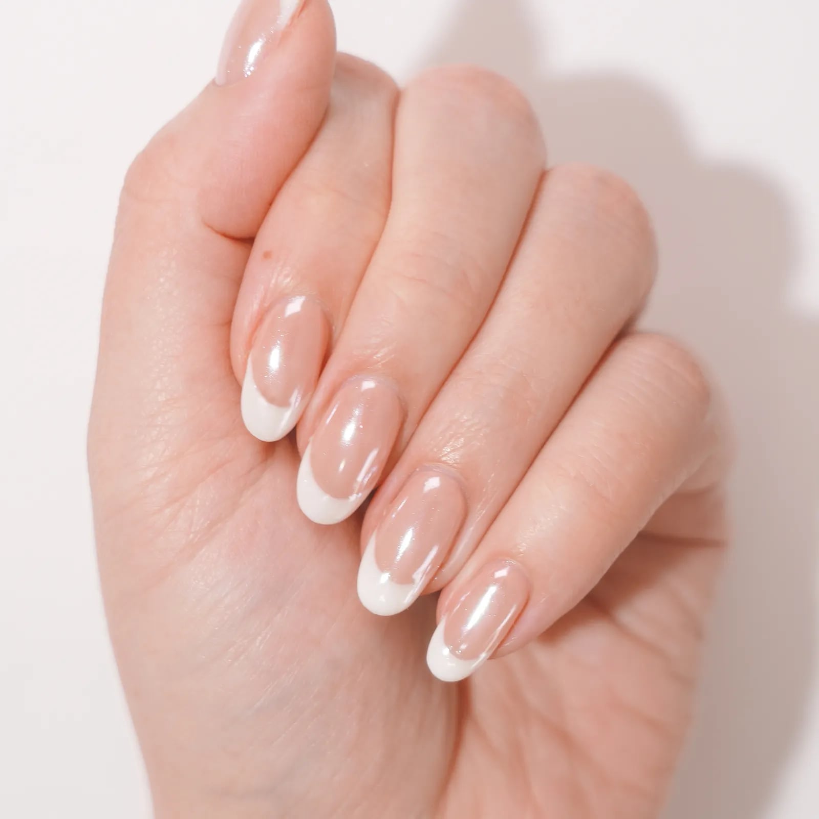 Sheer Nude Medium Oval Nails With White French Tip Sheer Nude Medium Oval Nails With White French Tip — Simple Nail Shapes
