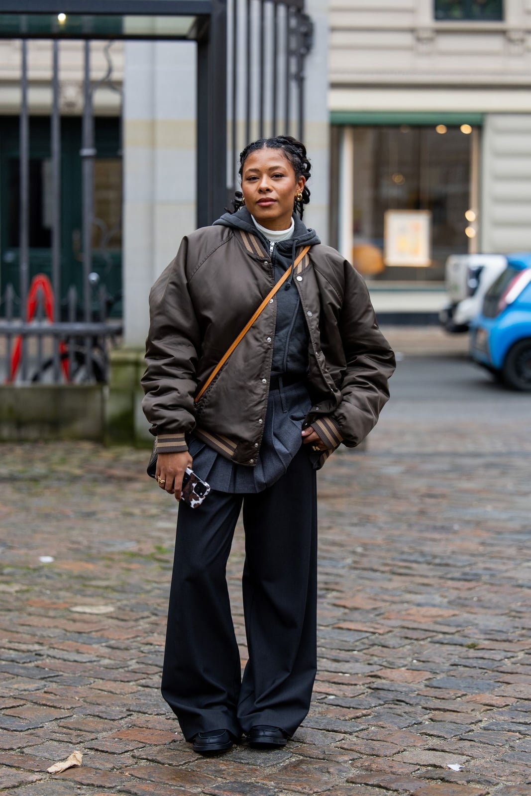 Brown Bomber Jacket Layered Over Hoodie — Simple Varsity Jacket Outfits