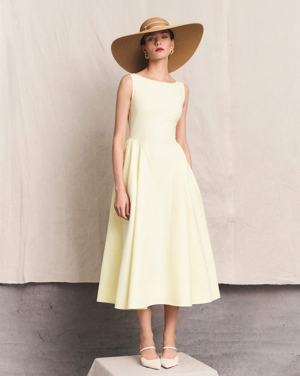 Pale yellow fit-and-flare midi dress with straw hat — Simple Wedding Guest Outfits