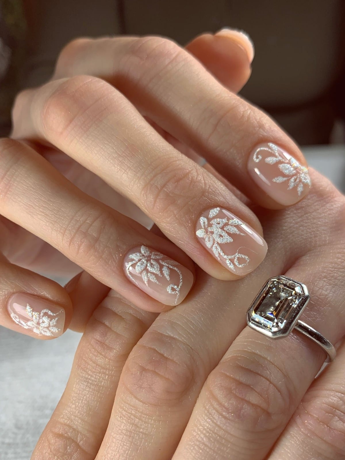 Shimmering Nude Oval Nails With White Floral Vines — Trendy Bridal Nails