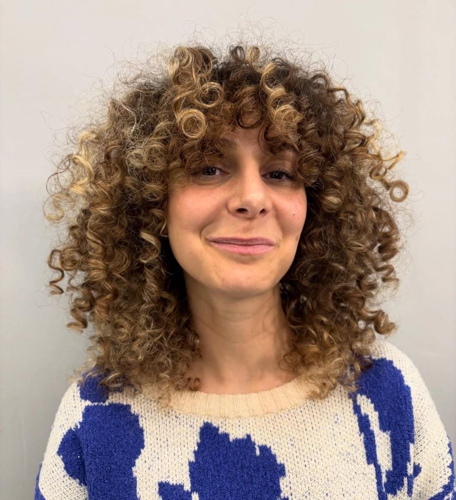 Shoulder Honey Blonde With Caramel Highlights — Trendy Curly Hair Color