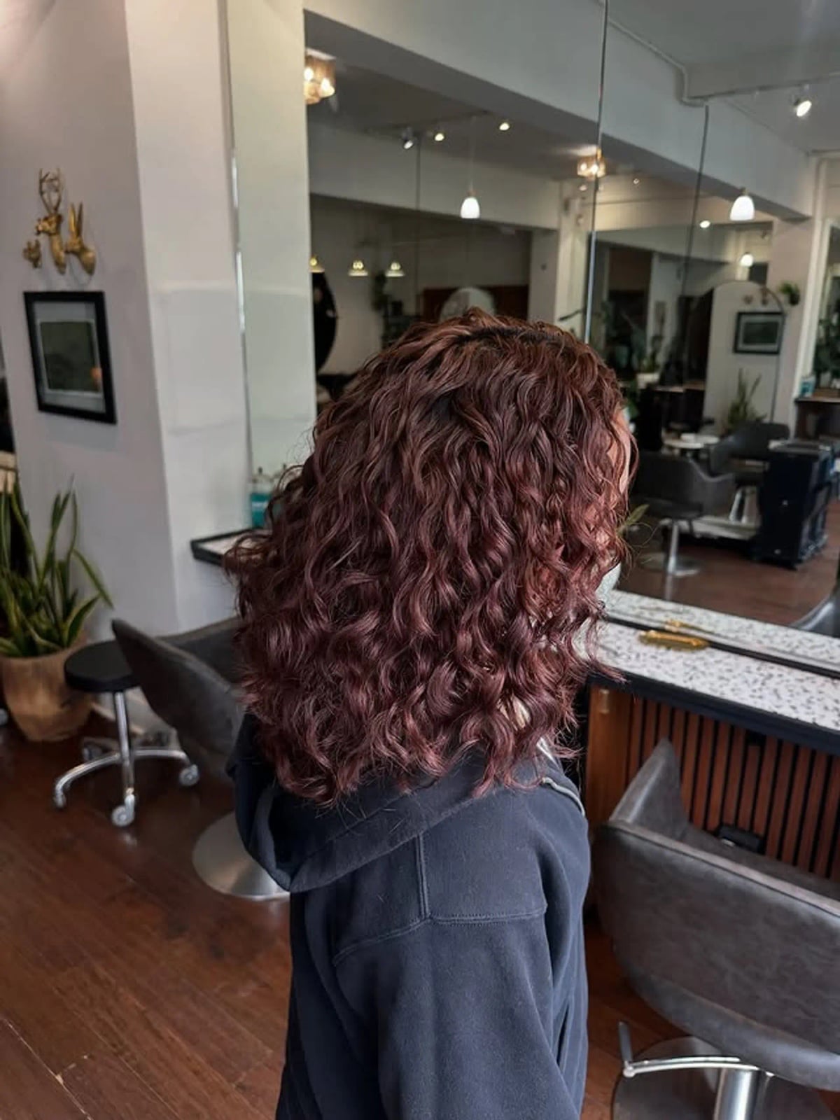 Collarbone Layered In Vibrant Burgundy — Trendy Curly Hair Color
