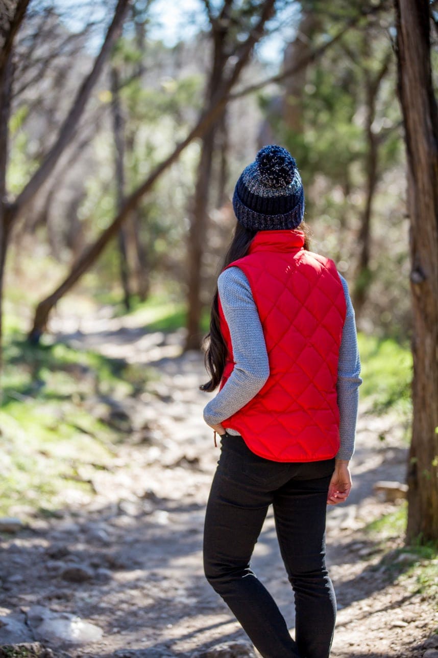 Red Puffer Vest with Black Pants and Blue Beanie — Trendy Cute Hiking Outfit