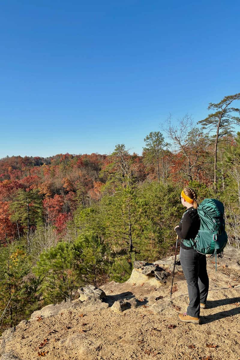 Black Pants and Shirt with Large Green Backpack — Trendy Cute Hiking Outfit