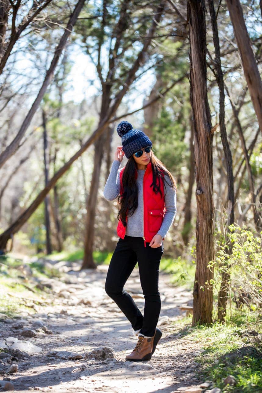 Red Puffer Vest with Gray Shirt and Black Pants, Brown Hiking Boots — Trendy Cute Hiking Outfit