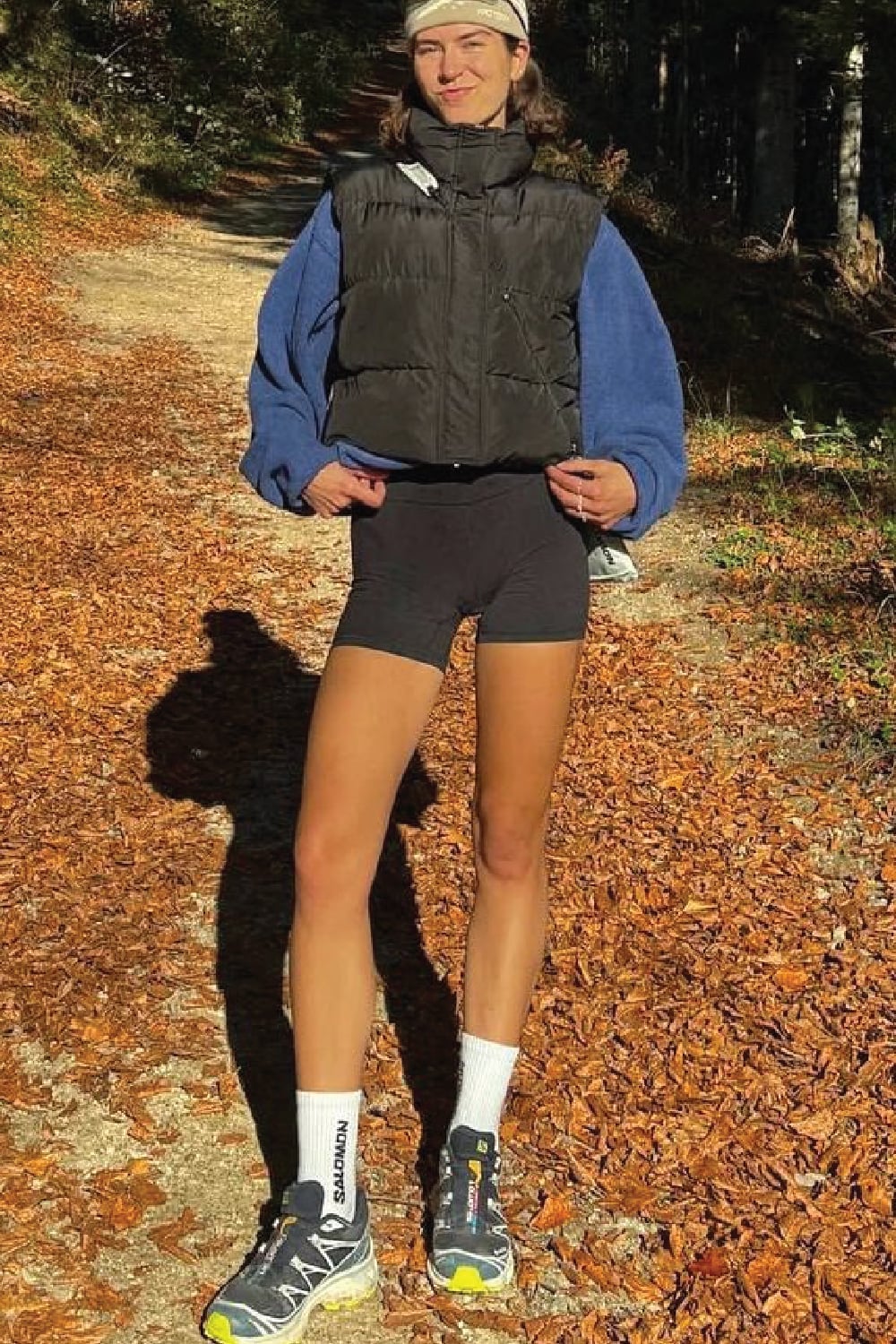Cropped Puffer Vest Over Blue Sweatshirt and Shorts — Trendy Cute Hiking Outfit