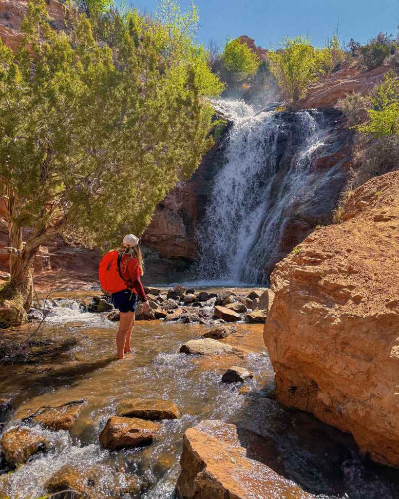 Red Long Sleeve Top with Blue Shorts and Orange Backpack — Trendy Cute Hiking Outfit