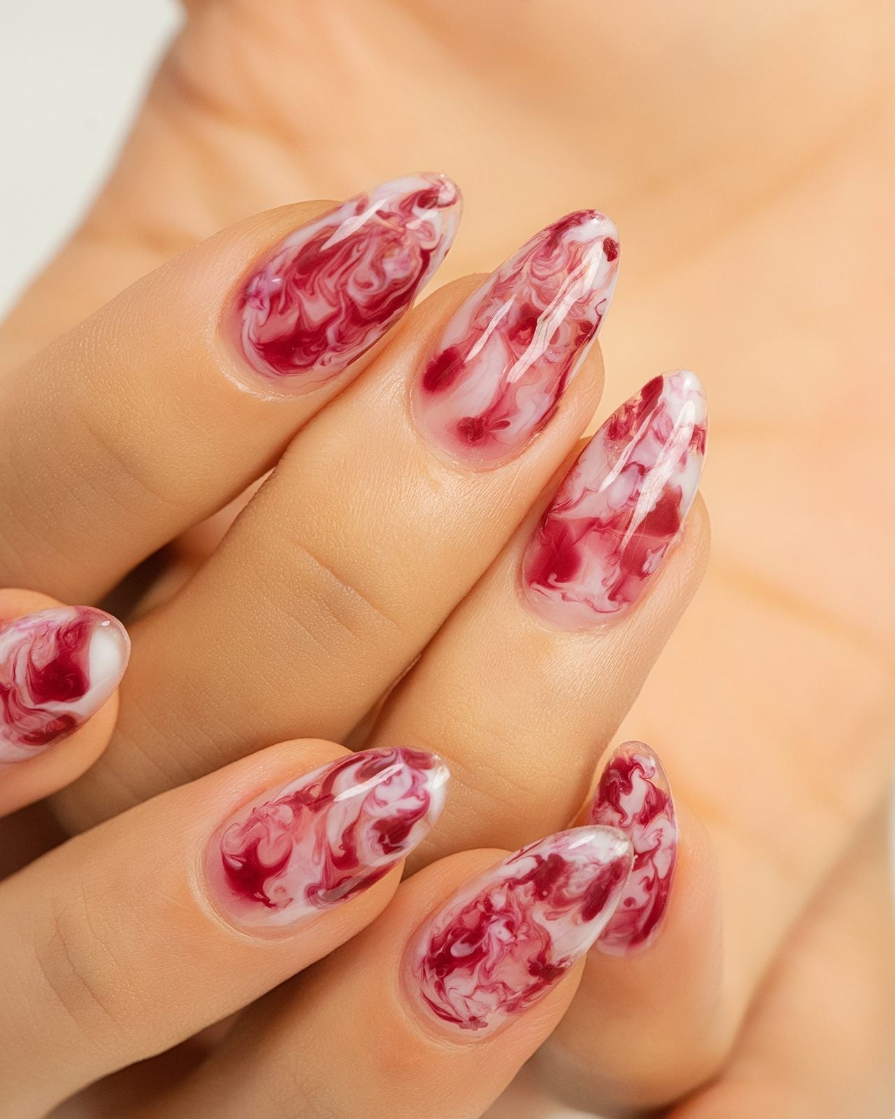 Red and White Marbled Jelly Almond Nails — Trendy Gel Nail Art