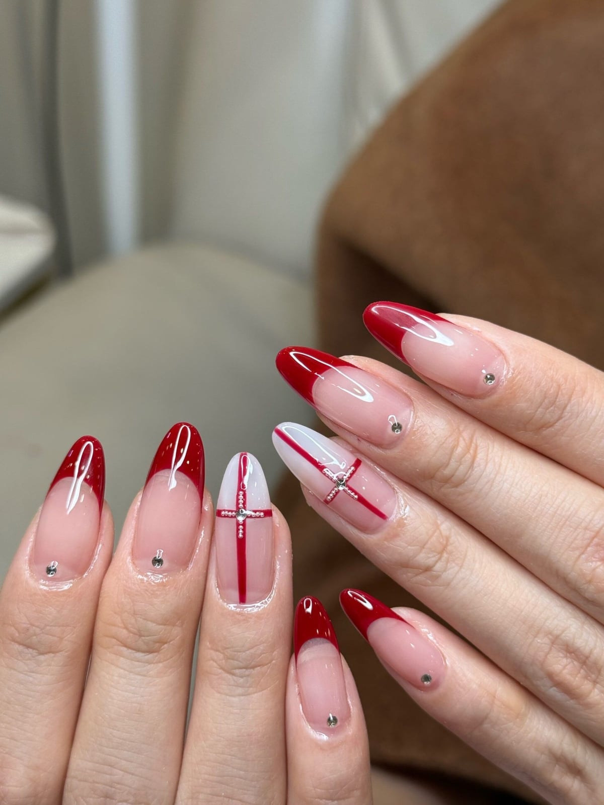 Red French Tip Almond Nails with Cross Design — Trendy Gel Nail Art
