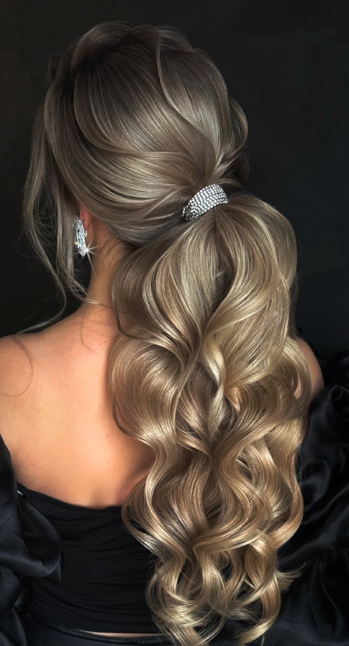 Voluminous Wavy Low Ponytail With Jeweled Tie Voluminous Wavy Low Ponytail With Jeweled Tie — Trendy Low Ponytail Hairstyles