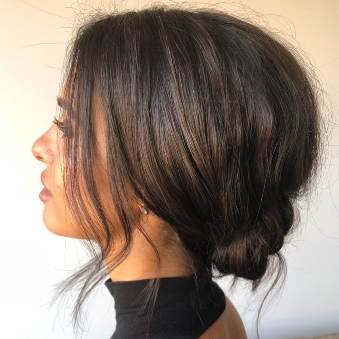 Low Messy Bun With Wispy Bangs Side Part Low Messy Bun With Wispy Bangs Side Part — Trendy Natural Bun