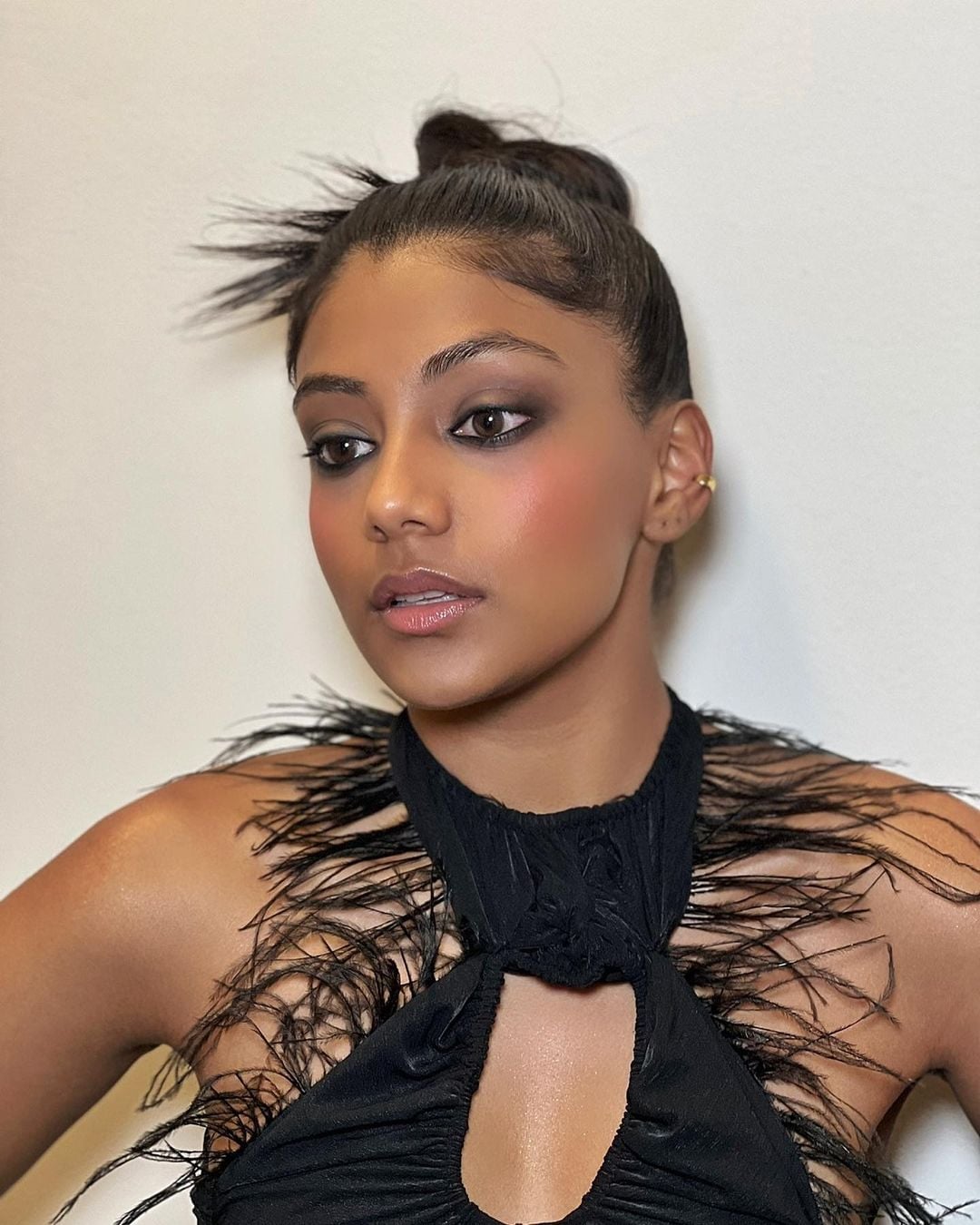 High Textured Black Bun With Wispy Bangs High Textured Black Bun With Wispy Bangs — Trendy Natural Bun