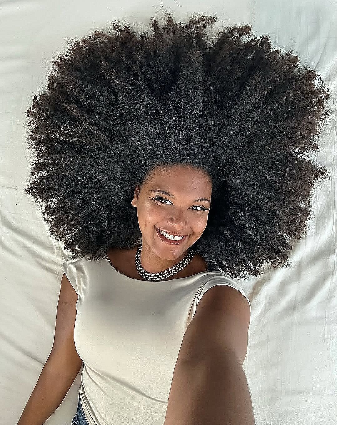 Voluminous Dark Coily Layered Afro, Extending To Mid-Back Voluminous Dark Coily Layered Afro, Extending To Mid-Back — Trendy Natural Hair Hairstyles
