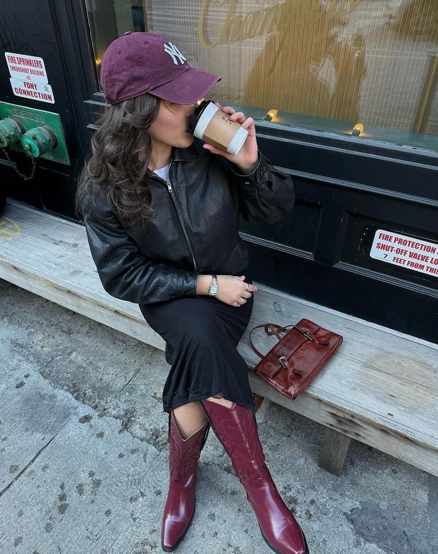Burgundy Cowboy Boots With Black Dress And Jacket — Trendy Red Boots Outfit