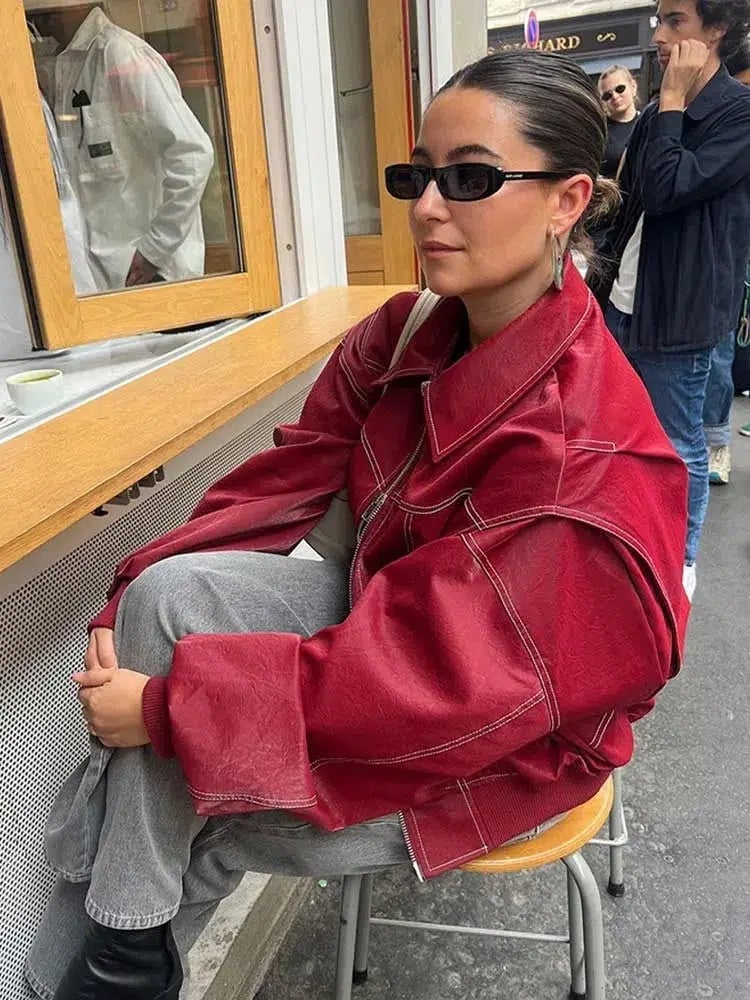 Red Leather Bomber Jacket With Stitched Panels And Gray Jeans Red Leather Bomber Jacket With Stitched Panels And Gray Jeans — Trendy Red Leather Jacket Outfit