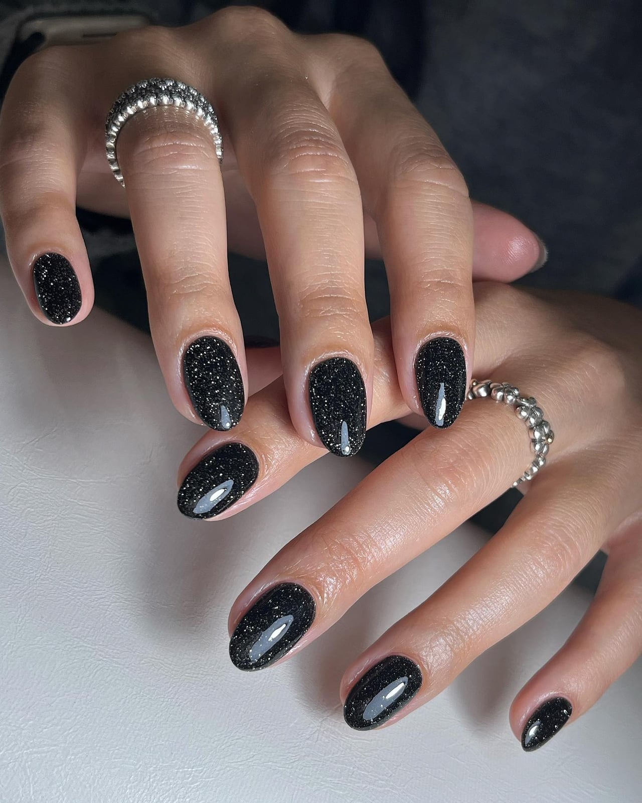 Glossy Black Short Almond Nails With Glitter — Trendy Short Black Nails