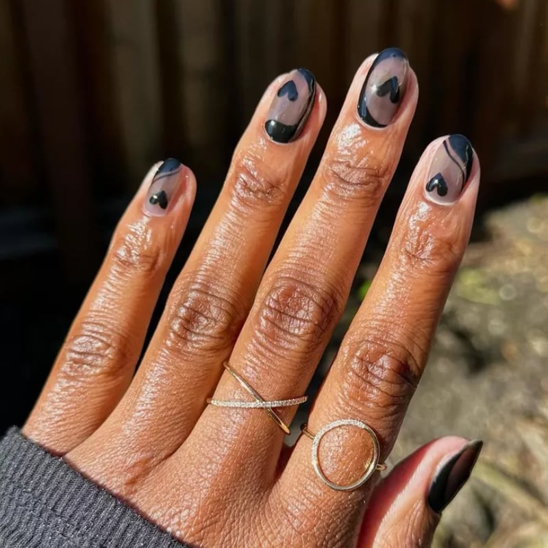Sheer Base Short Almond Nails With Black Hearts, Close-Up Take — Trendy Short Black Nails