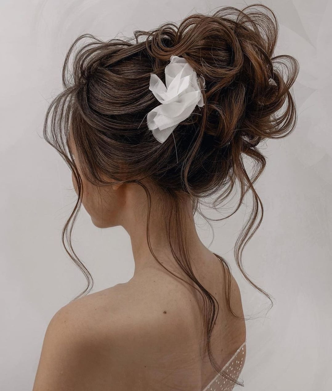 Messy Dark Brown Updo With Loose Tendrils — Trendy Wedding Bun