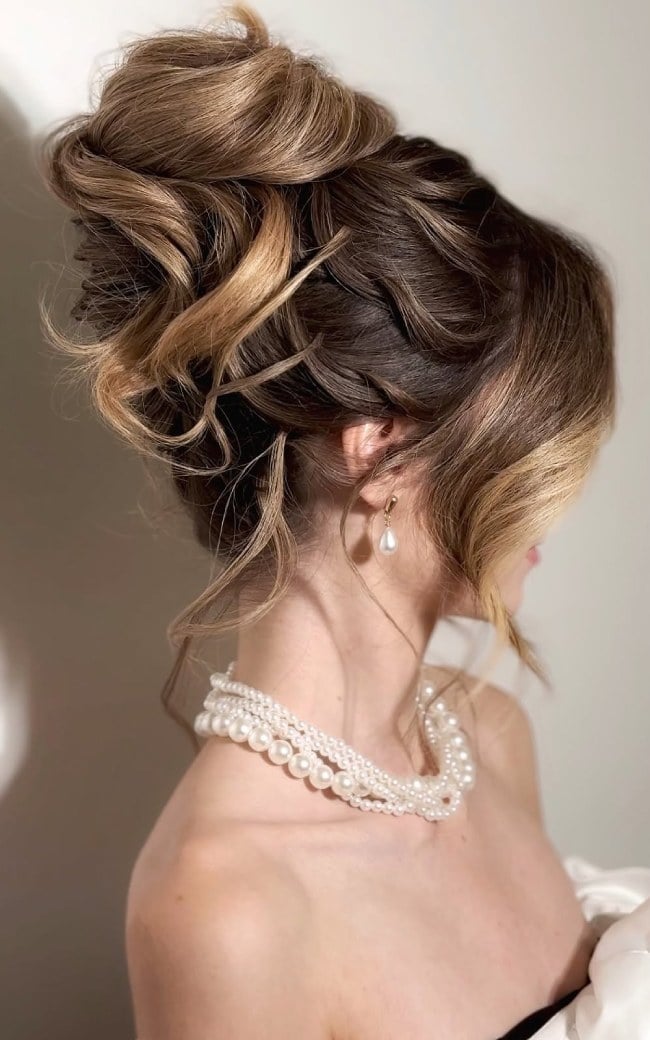 High Blonde Textured Bun With Loose Tendrils — Trendy Wedding Bun